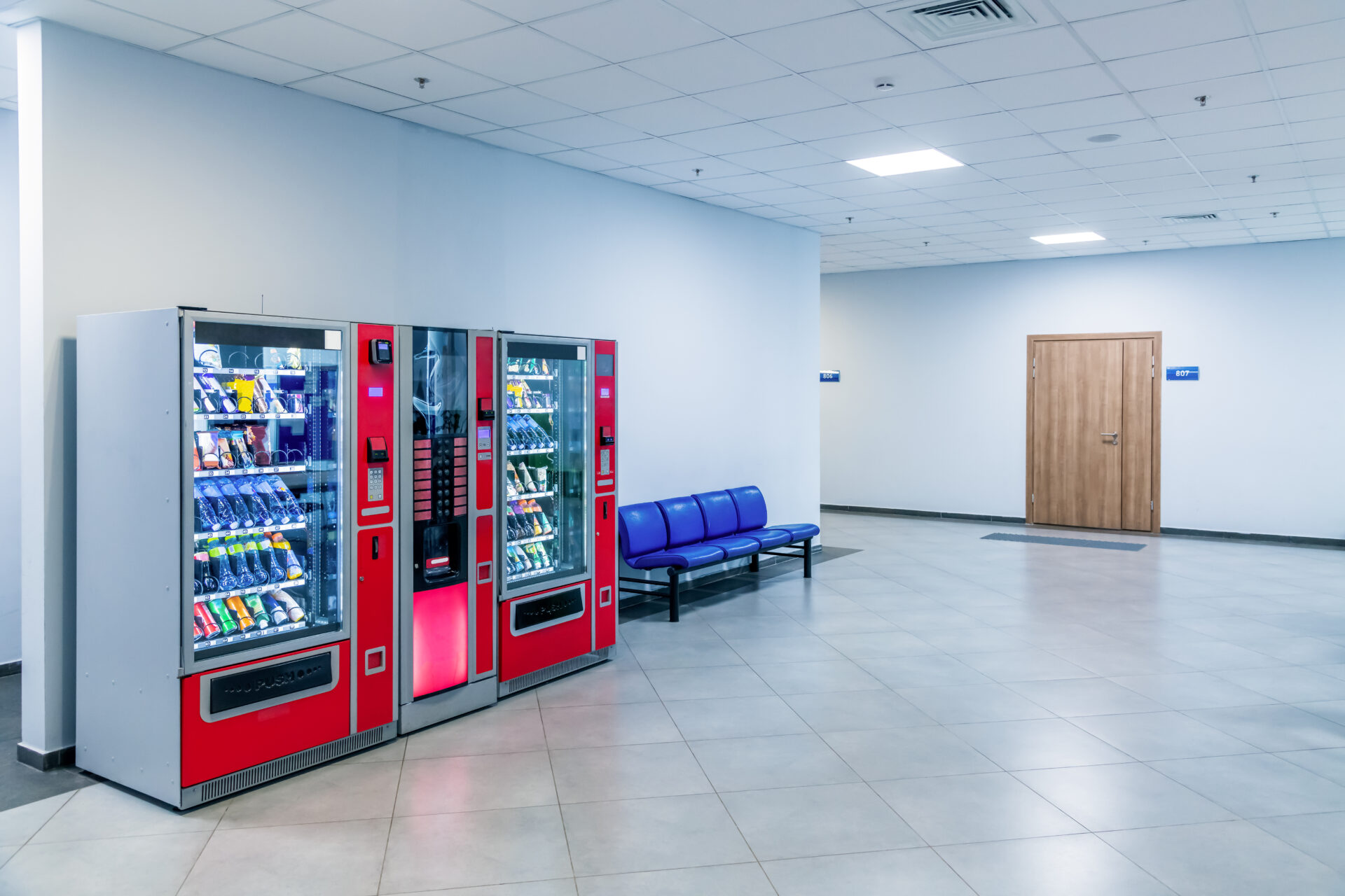 Red vending machines in hallway.